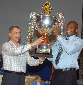 President Michel hands over the huge floating cup to Cupidon