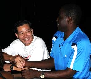 Coach Luo (left) shakes hands with Mr Bau