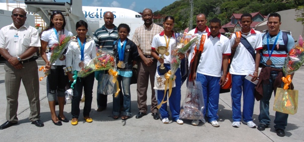 Minister Meriton (centre) and NSC head Volc�re (1st left) pose with the athletes and coaches